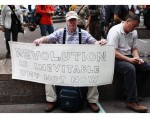 A man holds a sign with Occupy Wall Street campaign demonstrators in Zuccotti Park, near Wall Street in New York A man holds a sign with Occupy Wall Street campaign demonstrators in Zuccotti Park, near Wall Street in New York