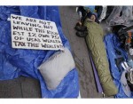 An Occupy Wall Street protester sleeps in Zuccotti Park in New York An Occupy Wall Street protester sleeps in Zuccotti Park in New York