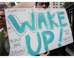 A protester marches with a sign A protester marches with a sign